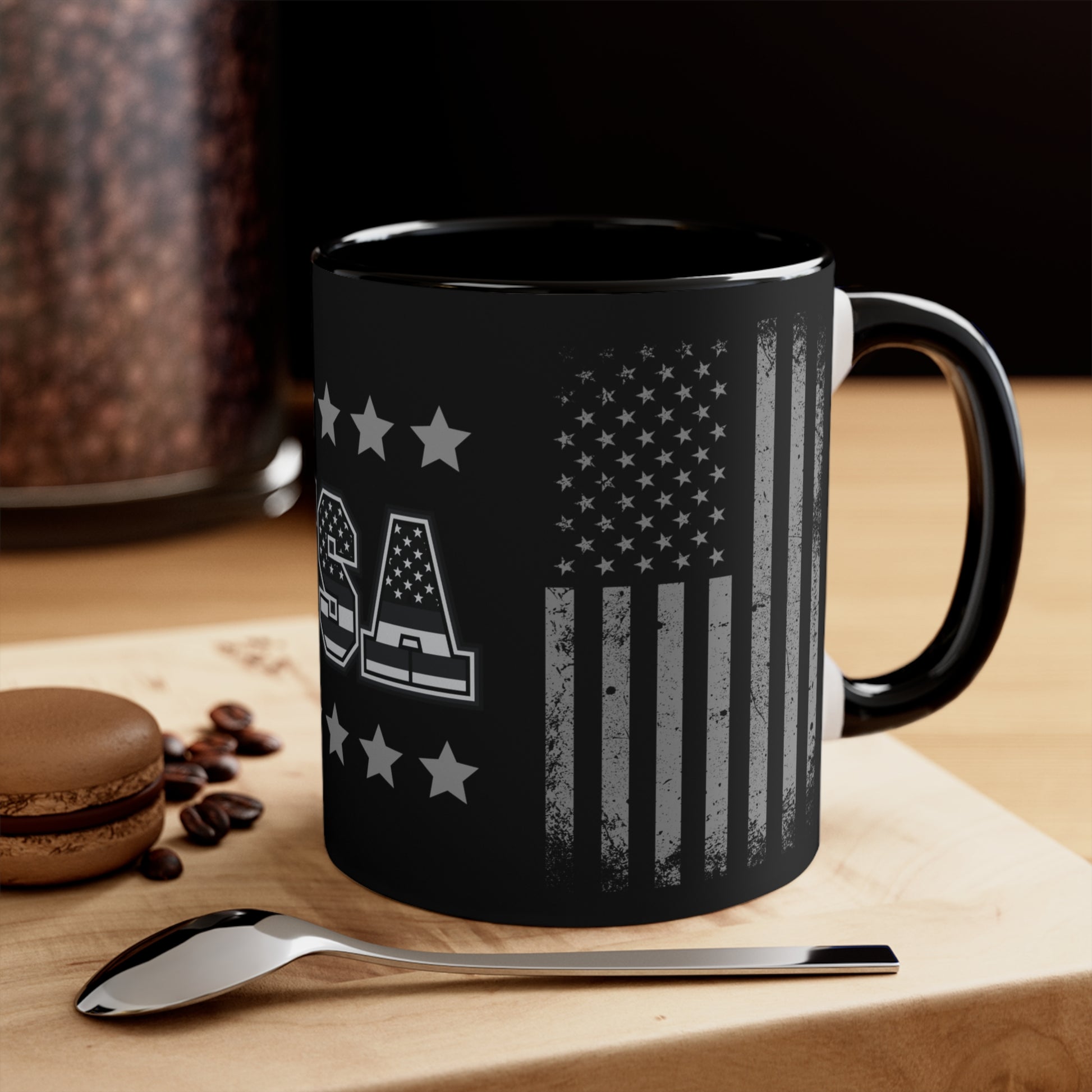 Introducing our Care and Wishes Boutique's 11-ounce coffee cup! This stunning ceramic coffee cup features a two-tone design with a black exterior. The design is dedicated to celebrating the American spirit, proudly displaying the iconic American flag with accent stars bordering top and bottom of USA. 