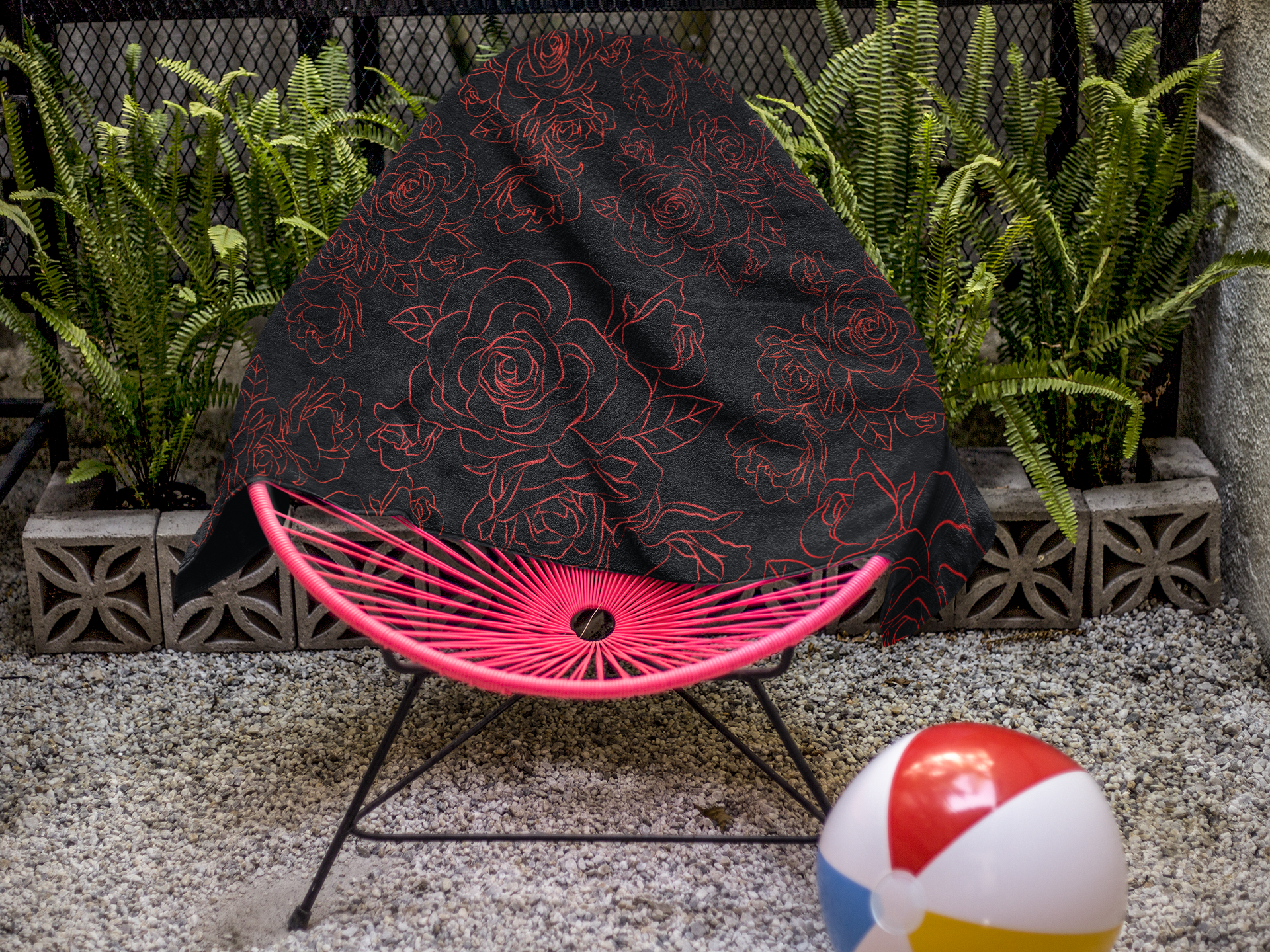 Picture shown is the Bold Rose Blossom Beach Towel displayed on a hammock style beach chair