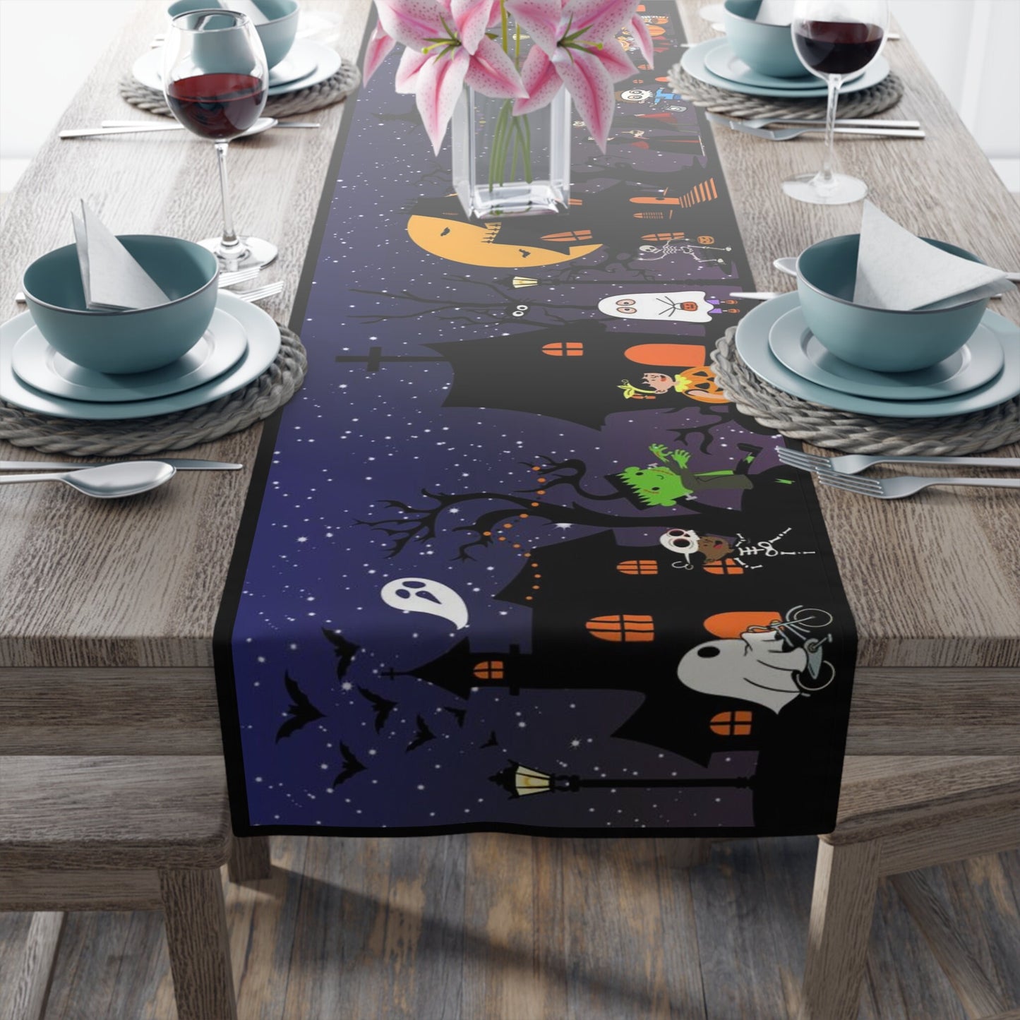 The background of the table runner depicts a dark starlit sky, setting the stage for a hauntingly beautiful scene. Spooky houses lurk in the distance, while trick-or-treaters roam the streets. From Frankensteins to skeletons and ghosts, this table runner showcases a delightful assortment of Halloween characters. Bats gracefully fly across the sky, while a wicked witch adds a touch of magic to the design.